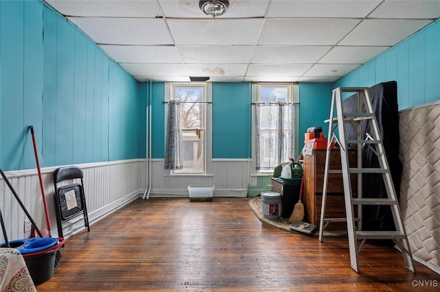 misc room with dark hardwood / wood-style floors and a drop ceiling