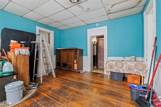 bedroom featuring a paneled ceiling and dark wood-type flooring