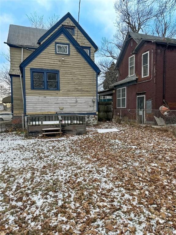 view of snow covered rear of property