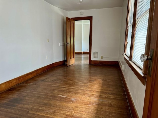 empty room with dark hardwood / wood-style floors