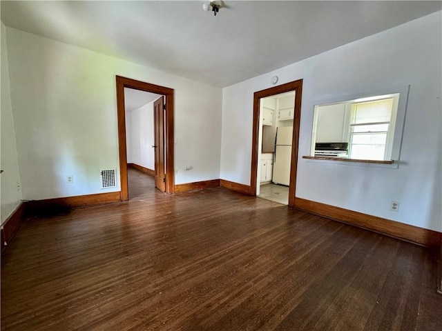 spare room with wood-type flooring