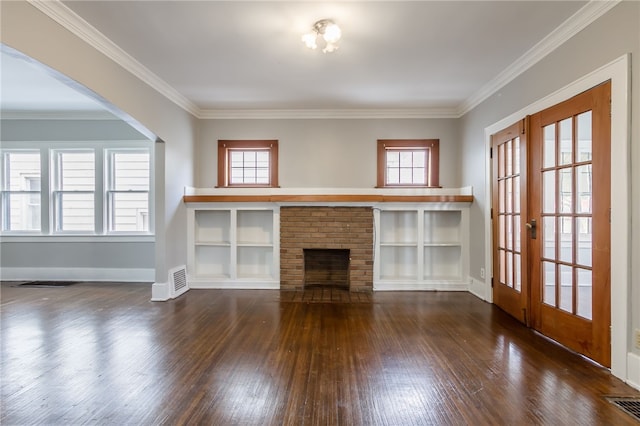 unfurnished living room featuring french doors, dark wood-type flooring, a brick fireplace, and ornamental molding