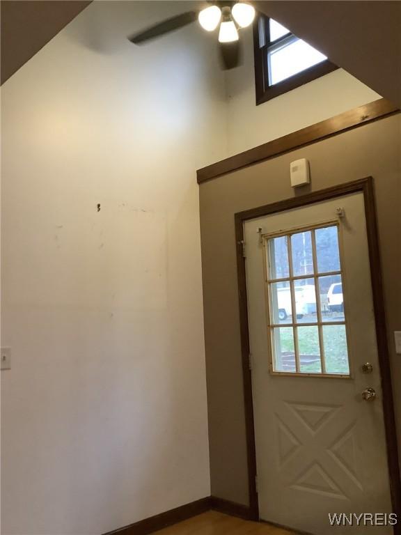 doorway to outside featuring ceiling fan