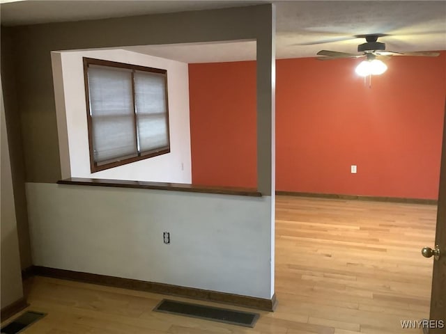 unfurnished room with light hardwood / wood-style floors and ceiling fan