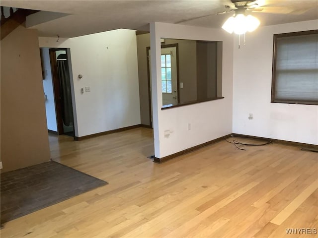 empty room featuring ceiling fan and light hardwood / wood-style flooring