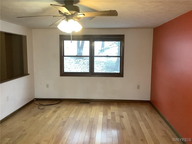 spare room featuring ceiling fan and light hardwood / wood-style flooring