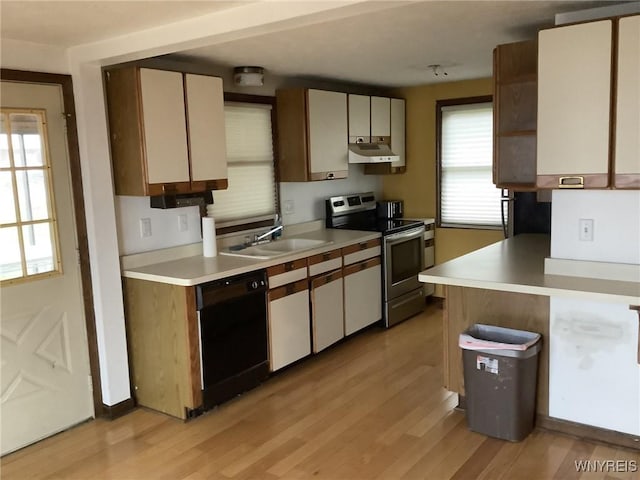 kitchen with sink, electric stove, black dishwasher, light hardwood / wood-style floors, and white cabinetry