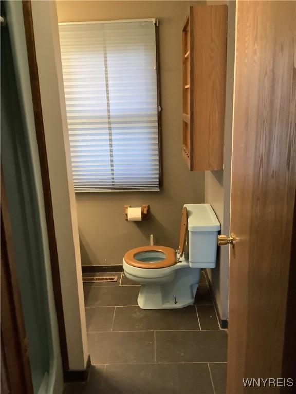 bathroom with tile patterned floors and toilet