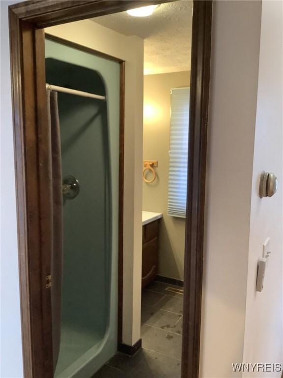 bathroom with a shower and vanity