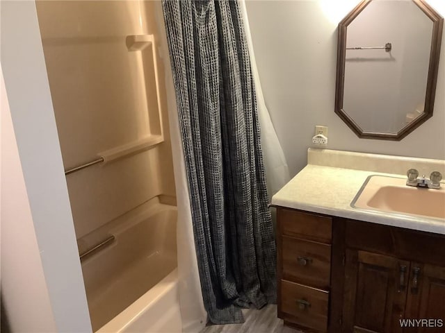 bathroom with hardwood / wood-style floors, vanity, and shower / bath combination with curtain