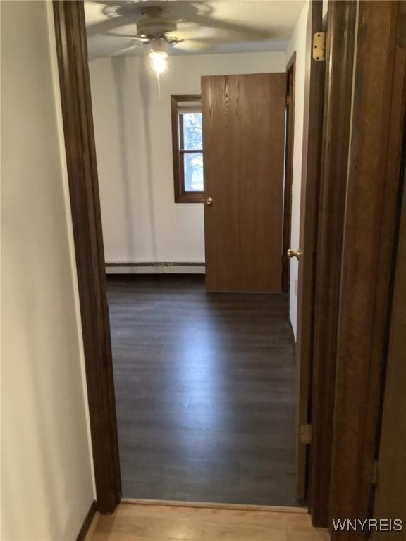 hall with hardwood / wood-style floors and a baseboard radiator