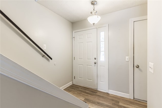 entryway featuring hardwood / wood-style floors and a textured ceiling