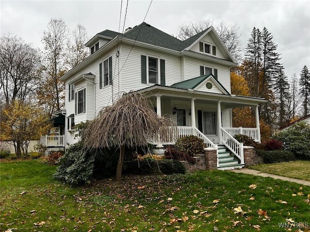 view of front of home featuring covered porch and a front yard