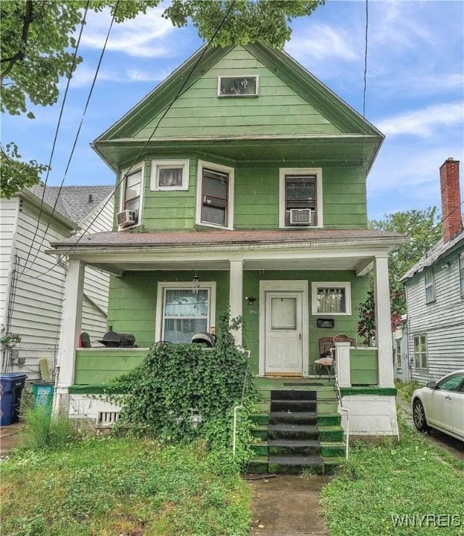 view of front of property with cooling unit and covered porch