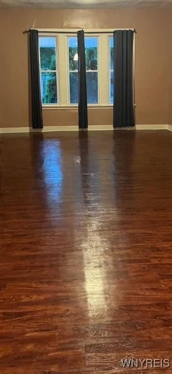 unfurnished room featuring dark hardwood / wood-style flooring