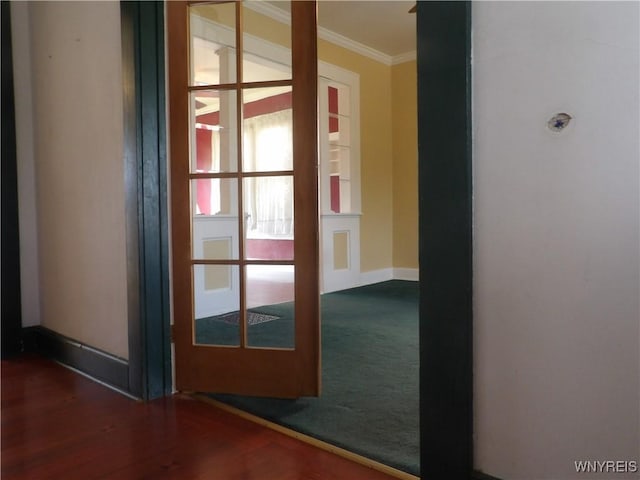 entryway with dark hardwood / wood-style floors, ornamental molding, and french doors