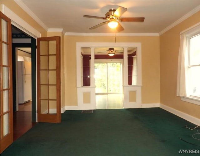 unfurnished room featuring a healthy amount of sunlight, crown molding, and french doors