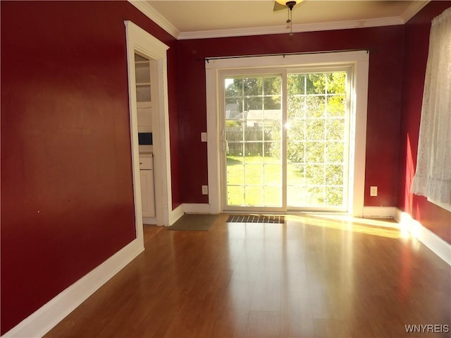 entryway with hardwood / wood-style floors and ornamental molding