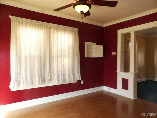 empty room featuring hardwood / wood-style floors, ceiling fan, and ornamental molding