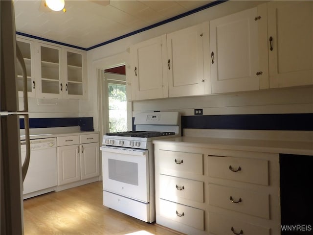 kitchen featuring white cabinets, white appliances, and light hardwood / wood-style flooring