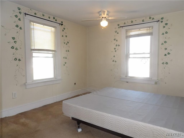 bedroom with multiple windows, carpet floors, and ceiling fan