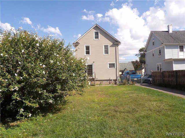 rear view of house with a lawn