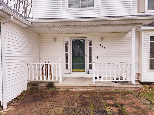 view of exterior entry featuring a porch