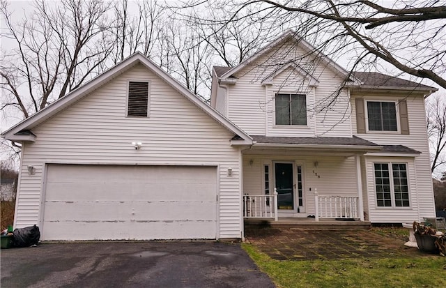 view of property featuring covered porch and a garage