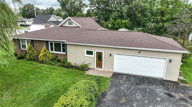 view of front of property featuring a garage and a front lawn