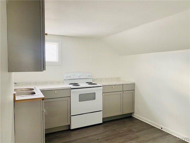 kitchen featuring gray cabinetry, sink, dark wood-type flooring, white electric range oven, and vaulted ceiling