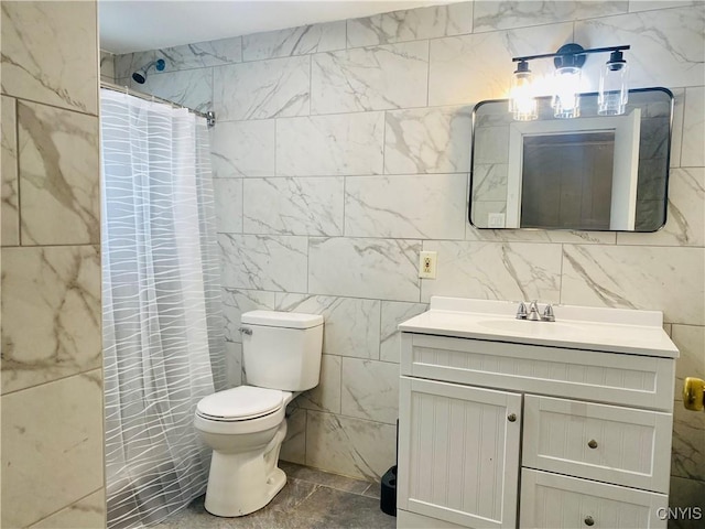 bathroom featuring a shower with shower curtain, vanity, toilet, and tile walls