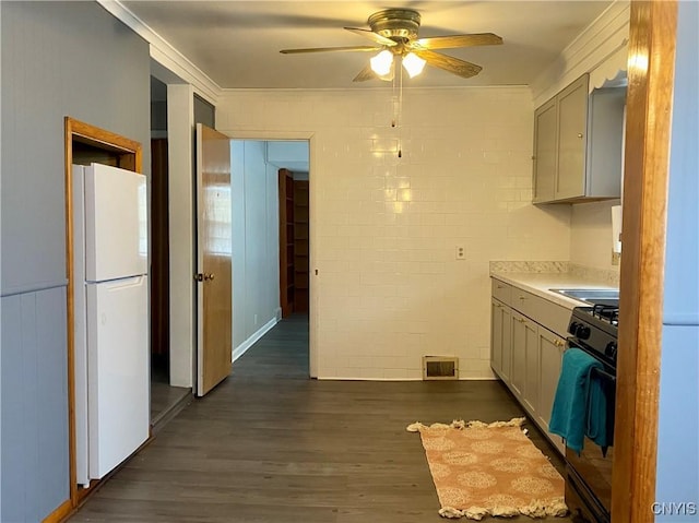 kitchen featuring ceiling fan, black range, dark wood-type flooring, and white refrigerator