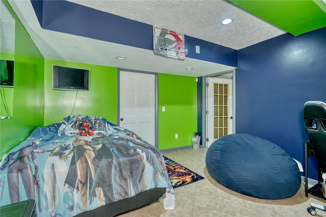 tiled bedroom featuring a textured ceiling