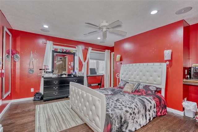 bedroom with ceiling fan and dark wood-type flooring