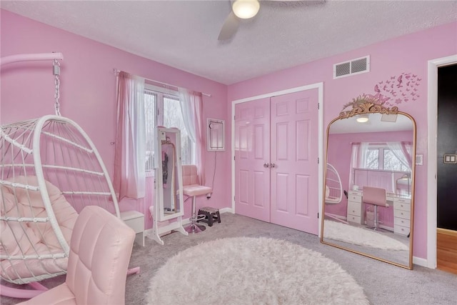 bedroom with ceiling fan, light colored carpet, a closet, and multiple windows