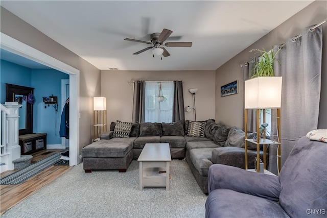 living room featuring ceiling fan and hardwood / wood-style floors