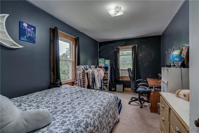 bedroom featuring light colored carpet and multiple windows