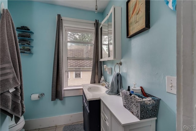 bathroom featuring tile patterned floors, vanity, and a healthy amount of sunlight