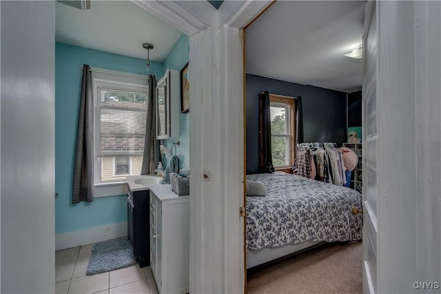 bedroom with sink and light tile patterned floors