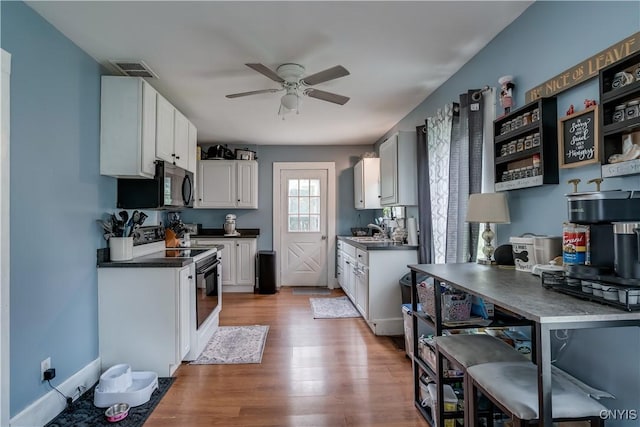 kitchen featuring white cabinetry, ceiling fan, sink, light hardwood / wood-style flooring, and electric stove