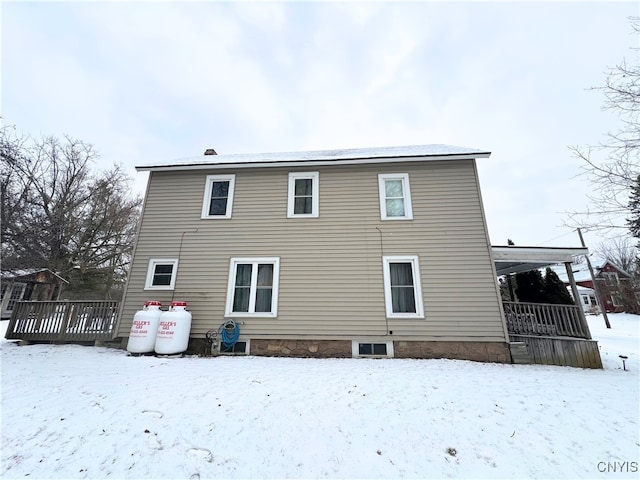 snow covered property featuring a deck