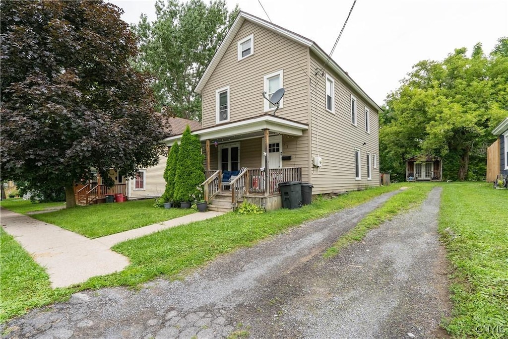 13 Avery Ave, Alexandria, NY 13607 - view of front of property with a porch, driveway, and a front yard