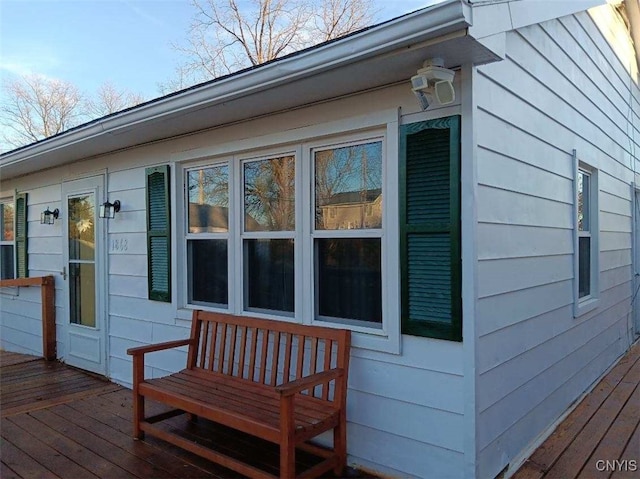 view of property exterior with a wooden deck