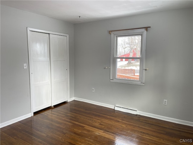 unfurnished bedroom with dark hardwood / wood-style flooring and a closet