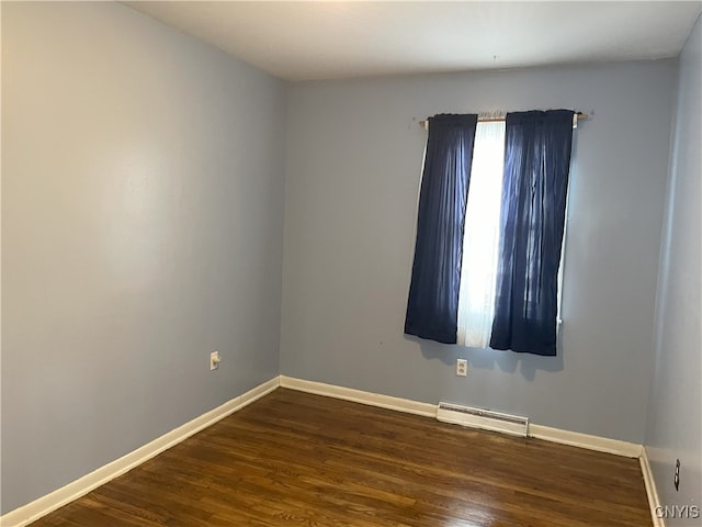 spare room with dark hardwood / wood-style flooring