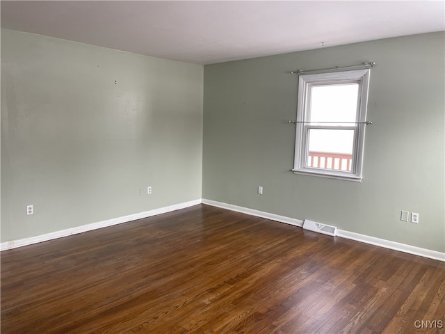 unfurnished room with dark hardwood / wood-style floors