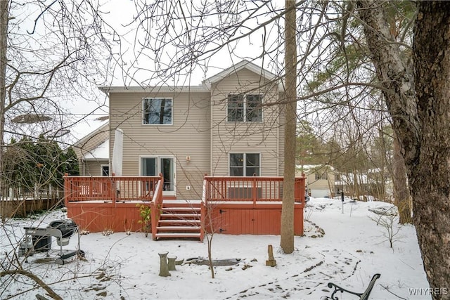 snow covered house with a deck