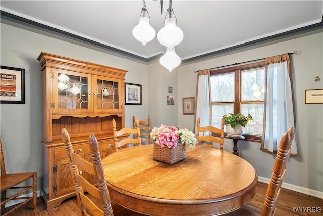 dining area with a notable chandelier and dark hardwood / wood-style floors