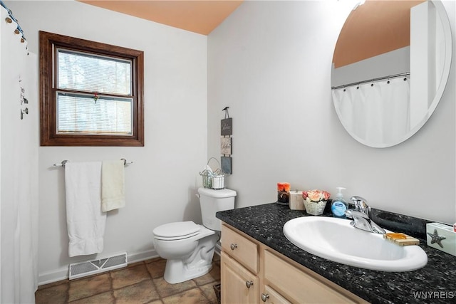 bathroom featuring vanity and toilet