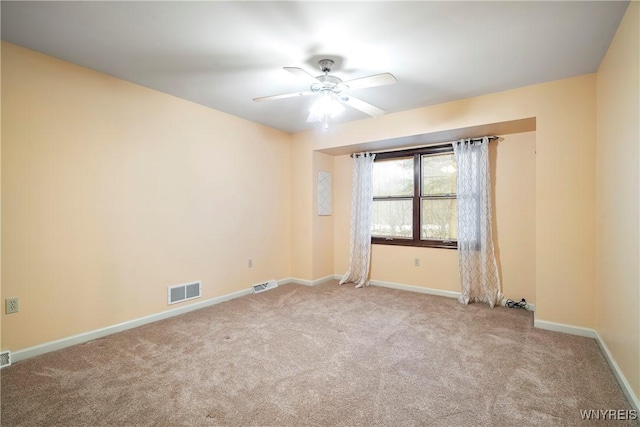 carpeted spare room with ceiling fan